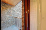 Discover the charm of this stunning property, showcasing exquisite stone walls and a beautifully crafted wooden ceiling.