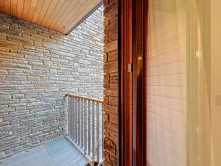 Discover the charm of this stunning property, showcasing exquisite stone walls and a beautifully crafted wooden ceiling.
