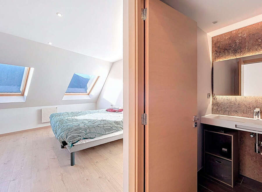 Discover this stunning property featuring a bright bedroom with natural light streaming in from the skylights.