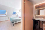 Discover this stunning property featuring a bright bedroom with natural light streaming in from the skylights.