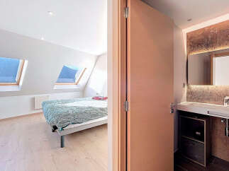 Discover this stunning property featuring a bright bedroom with natural light streaming in from the skylights.