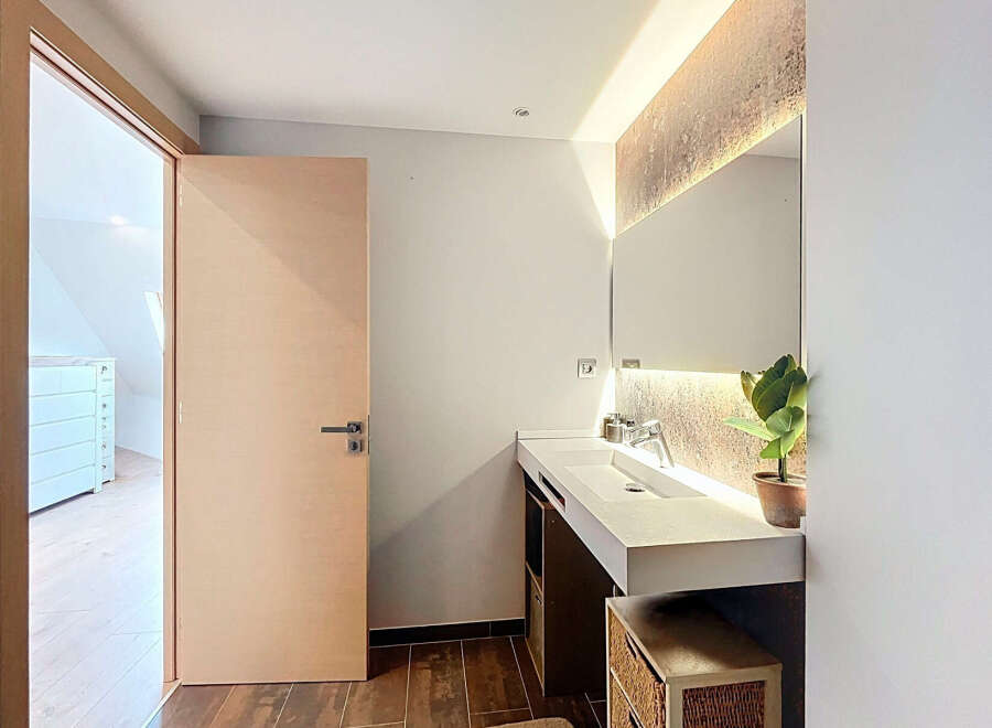 Step into this modern bathroom, featuring a sleek design and contemporary finishes.