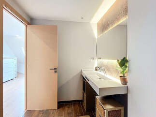 Step into this modern bathroom, featuring a sleek design and contemporary finishes.