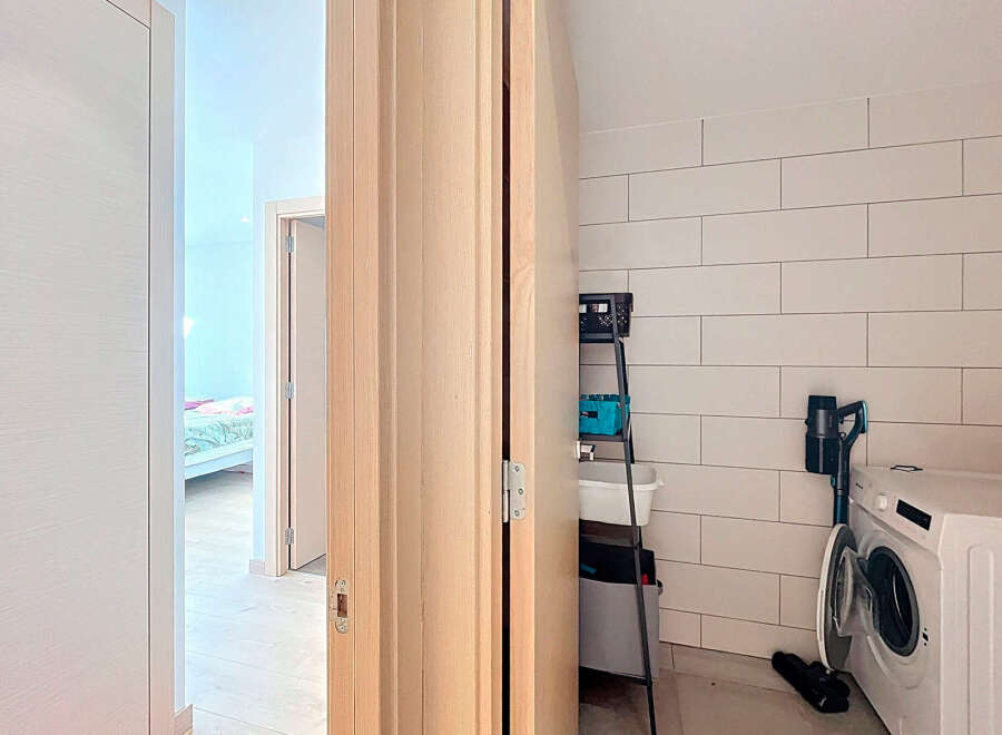 Discover the perfect blend of functionality and style in this modern laundry room.