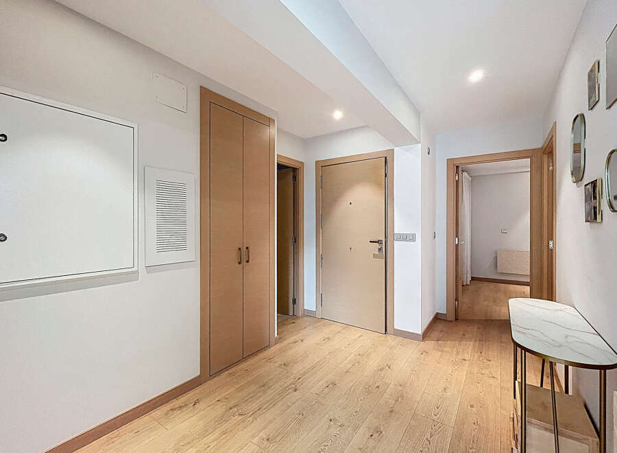Step into this beautifully designed entryway, featuring warm wooden floors and a neutral color palette that creates a welcoming atmosphere.