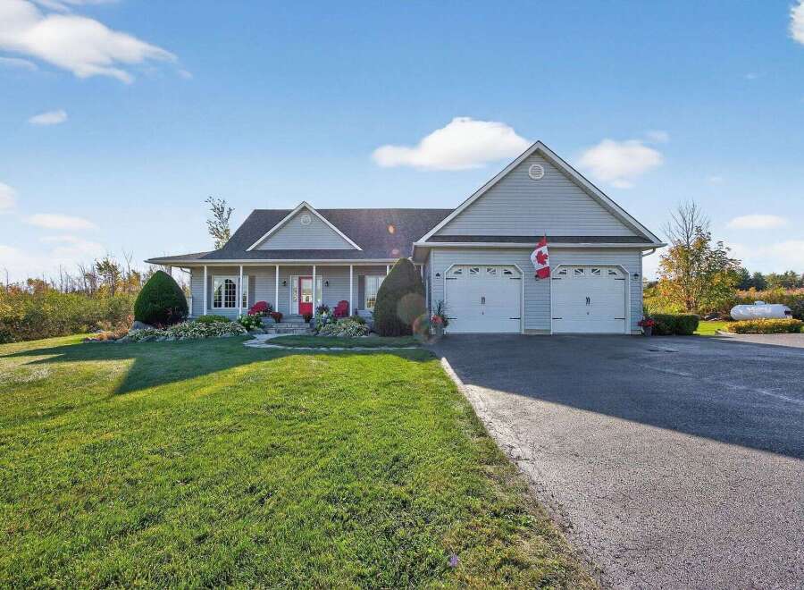 This stunning property boasts a beautifully maintained exterior with a spacious lawn and a welcoming front porch.