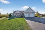 This stunning property boasts a beautifully maintained exterior with a spacious lawn and a welcoming front porch.