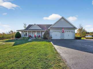 This stunning property boasts a beautifully maintained exterior with a spacious lawn and a welcoming front porch.