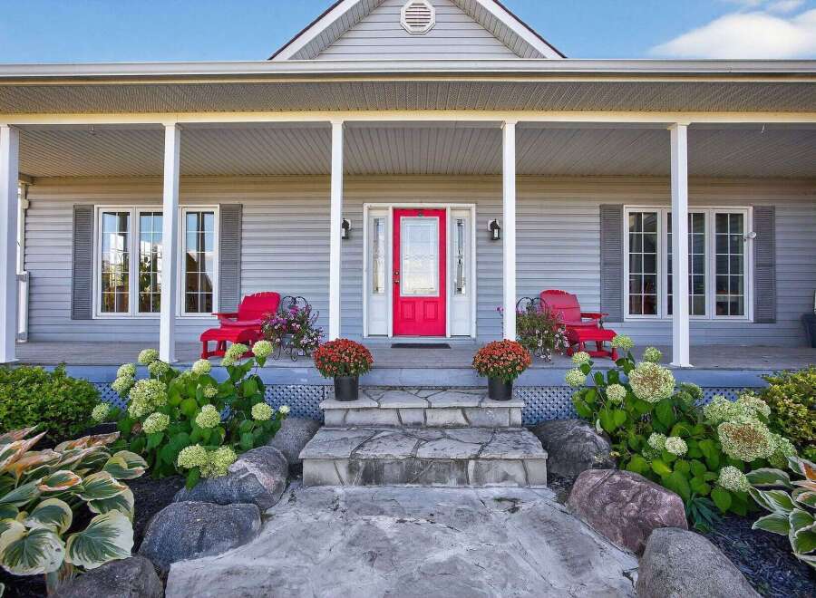 This charming home boasts a welcoming front porch, perfect for enjoying the outdoors.