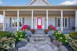 This charming home boasts a welcoming front porch, perfect for enjoying the outdoors.