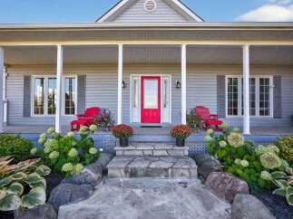 This charming home boasts a welcoming front porch, perfect for enjoying the outdoors.