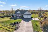 This stunning property boasts a beautiful home with a spacious driveway and a well-maintained lawn.