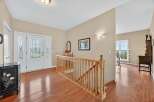 Step into this inviting entryway, showcasing beautiful hardwood floors and a grand staircase.