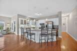 This stunning kitchen boasts a modern design with sleek white cabinetry and a spacious island, perfect for entertaining.