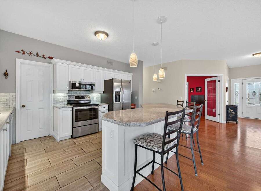 Step into this stunning kitchen, featuring modern stainless steel appliances and a spacious island perfect for entertaining.