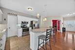 Step into this stunning kitchen, featuring modern stainless steel appliances and a spacious island perfect for entertaining.