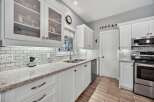 This stunning kitchen boasts a bright and airy design, perfect for culinary enthusiasts.