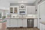 This stunning kitchen boasts bright white cabinetry, offering a clean and modern aesthetic.