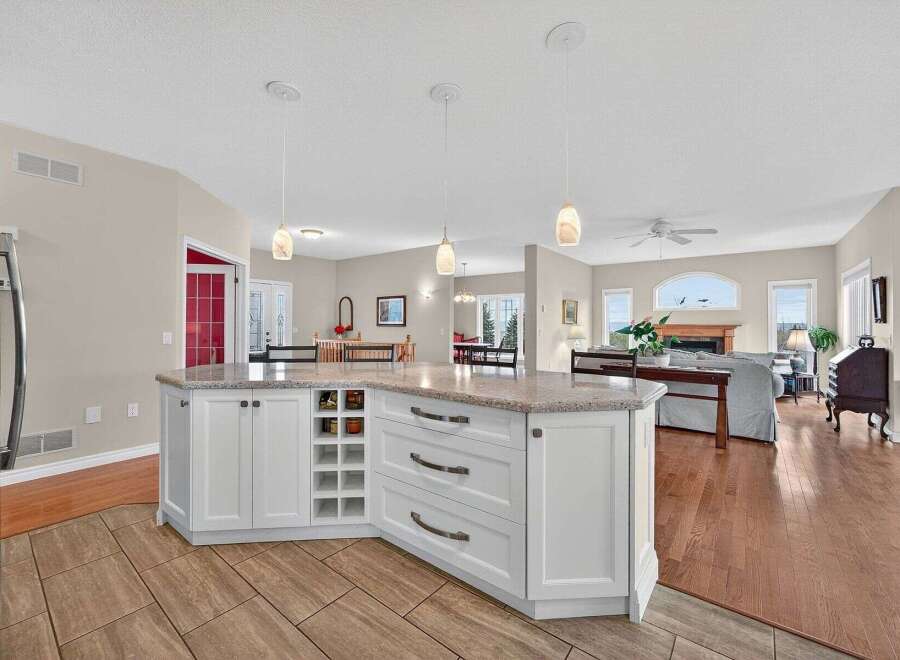This stunning kitchen boasts a spacious island with ample storage and a beautiful countertop, perfect for meal preparation and entertaining.