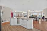 This stunning kitchen boasts a spacious island with ample storage and a beautiful countertop, perfect for meal preparation and entertaining.