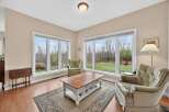 This inviting living space boasts abundant natural light, thanks to the large windows that offer stunning views of the surrounding landscape.