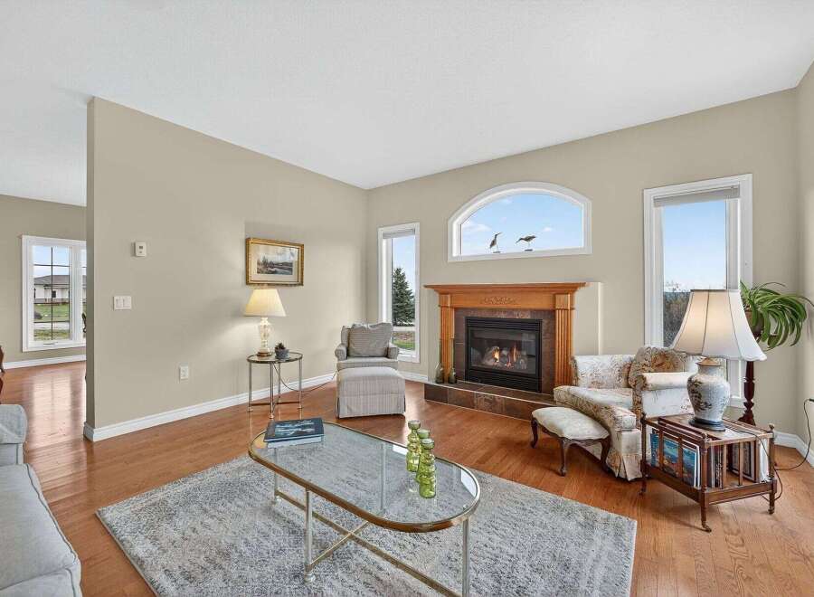 This stunning living room boasts a cozy fireplace, perfect for those chilly evenings.