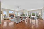 Step into luxury with this stunning living room, boasting a cozy fireplace and elegant hardwood floors.