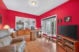 This stunning home office boasts a vibrant red wall, creating a bold and inviting atmosphere.