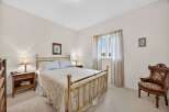 This charming bedroom features a classic brass bed frame, creating a timeless and elegant atmosphere.