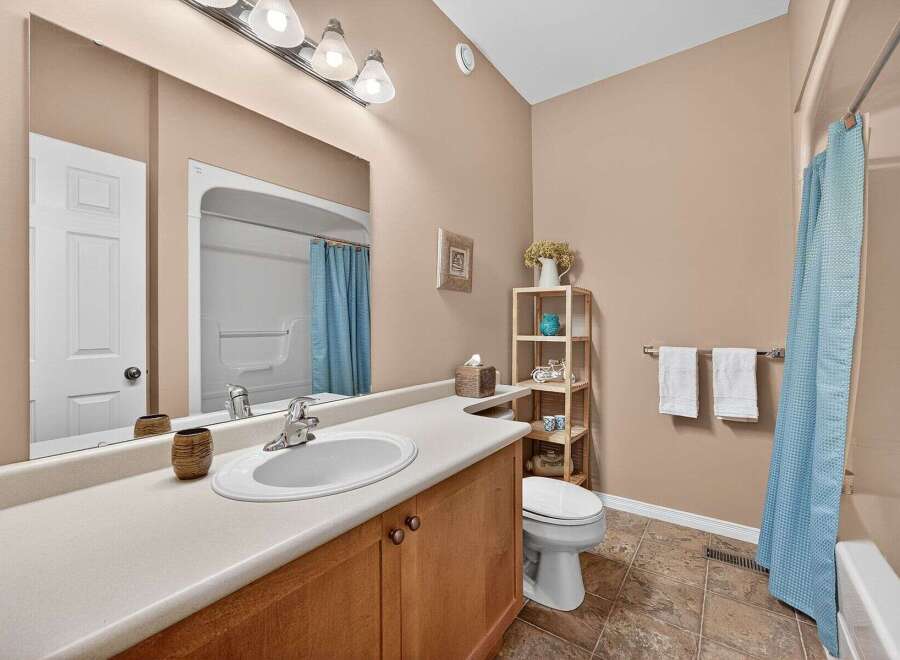 This inviting bathroom features a bright and airy design, perfect for starting your day.