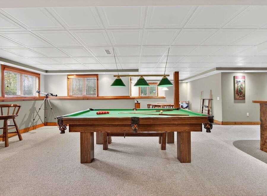 This inviting basement features a classic pool table, perfect for entertaining and relaxation.