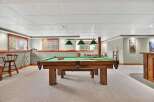 This inviting basement features a classic pool table, perfect for entertaining and relaxation.