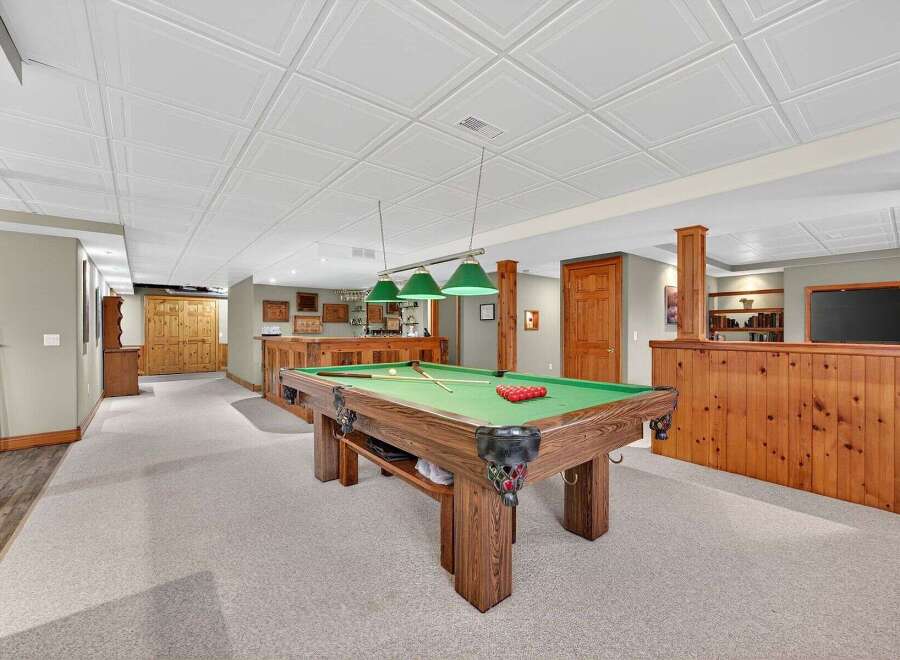 This stunning property boasts a luxurious game room, perfect for entertaining guests.