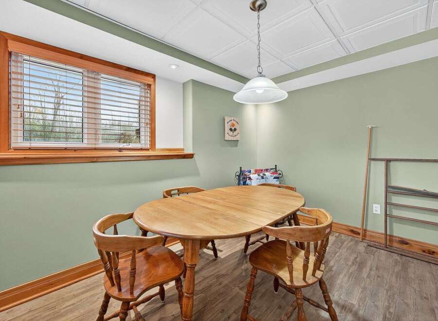 This charming dining area features a beautiful wooden table and chairs, perfect for family gatherings or intimate meals.