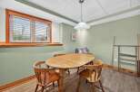 This charming dining area features a beautiful wooden table and chairs, perfect for family gatherings or intimate meals.
