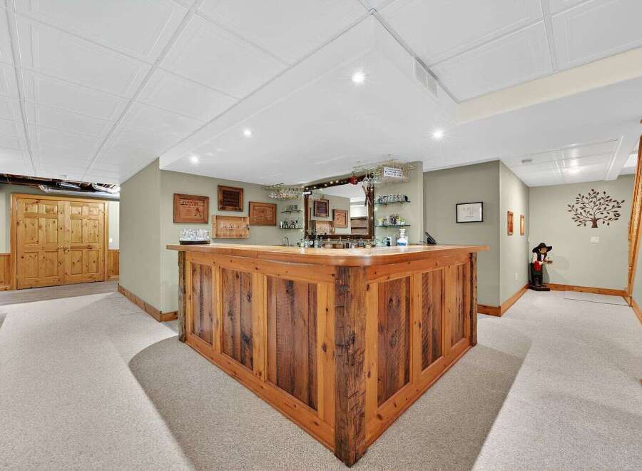 This stunning property features a custom-built wooden bar, perfect for entertaining guests.
