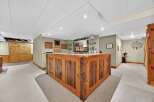 This stunning property features a custom-built wooden bar, perfect for entertaining guests.