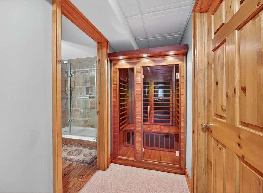 Step into relaxation with this stunning property featuring a luxurious sauna and a beautifully designed shower.