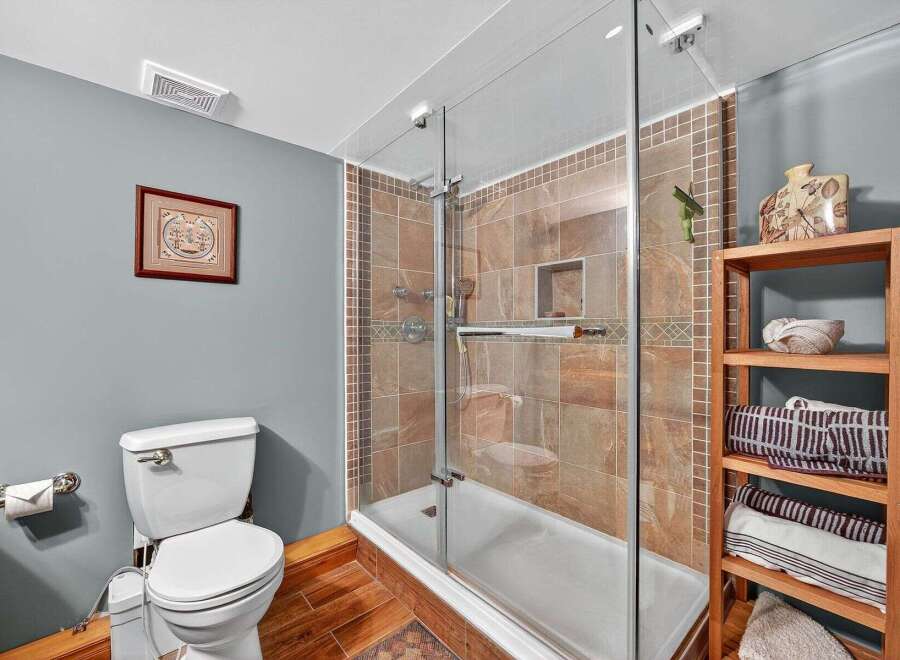 Step into a beautifully designed bathroom featuring a modern glass shower and elegant tile work.