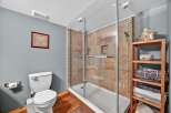 Step into a beautifully designed bathroom featuring a modern glass shower and elegant tile work.