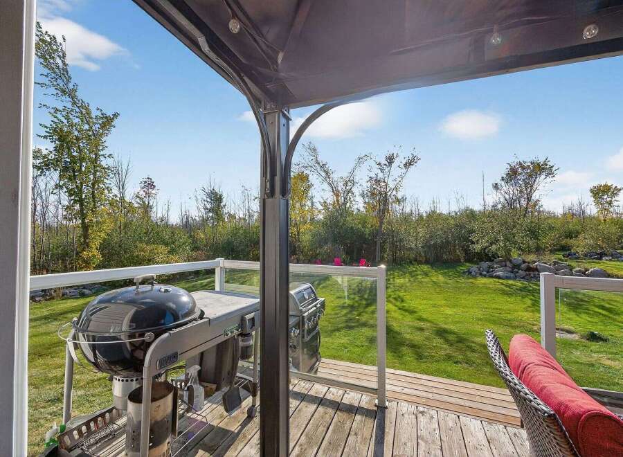 Enjoy outdoor living at its finest with this stunning property! This home features a beautiful deck with a grill, perfect for entertaining.