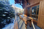 Enjoy breathtaking mountain views from this charming chalet balcony.