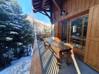 Enjoy breathtaking mountain views from this charming chalet balcony.