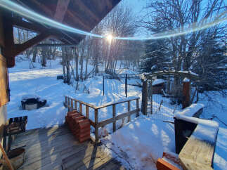 This charming property offers a serene winter landscape, perfect for those seeking a peaceful retreat.