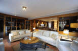 This stunning property boasts a spacious living area with a unique, rustic coffee table as its centerpiece.