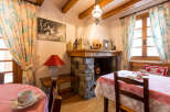 Step into the charm of this cozy property, featuring a rustic fireplace and inviting dining area.