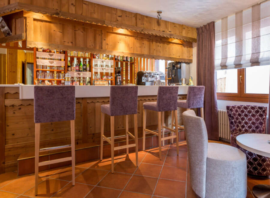 This charming bar area features a rustic wooden design, creating a warm and inviting atmosphere.