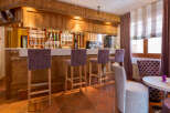 This charming bar area features a rustic wooden design, creating a warm and inviting atmosphere.