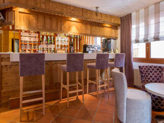 This charming bar area features a rustic wooden design, creating a warm and inviting atmosphere.