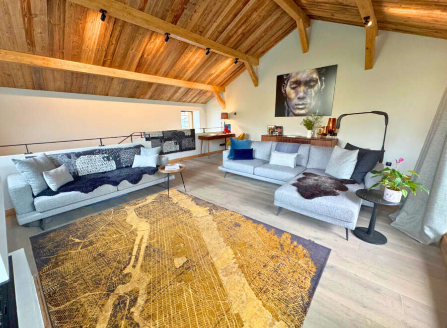 This stunning property boasts a spacious living area with a unique wooden ceiling, creating a warm and inviting atmosphere.